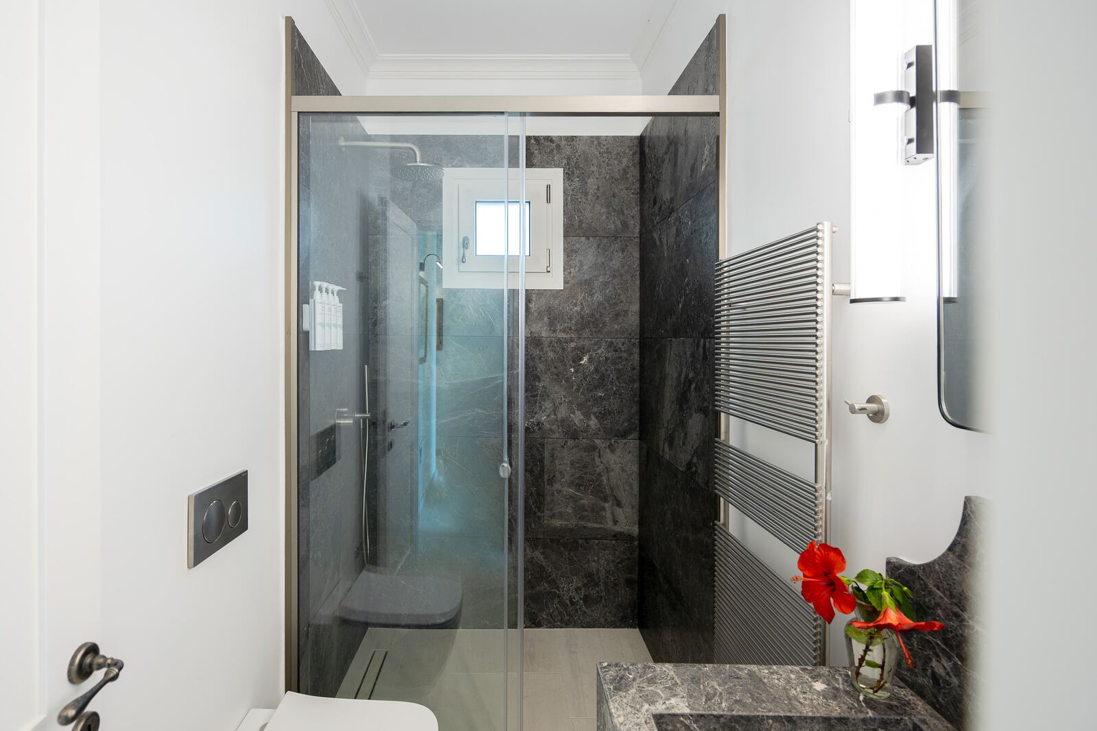 Grey marble walk-in shower with glass screen