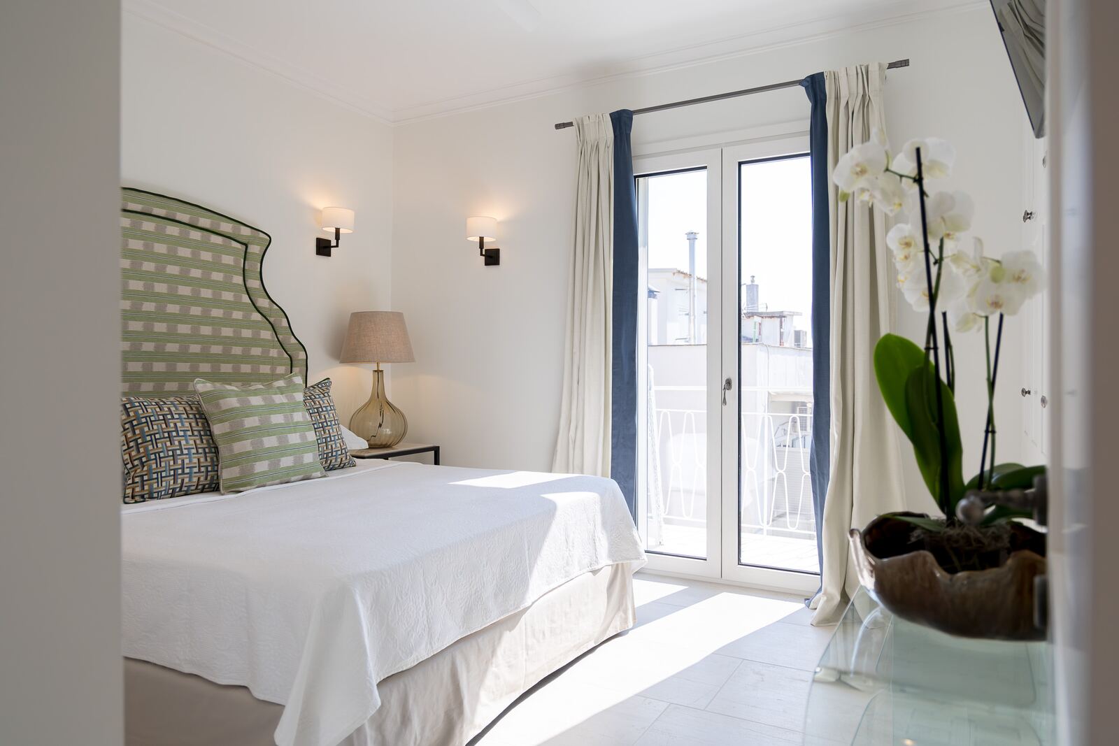 Bedroom three with the balcony door open to the morning light