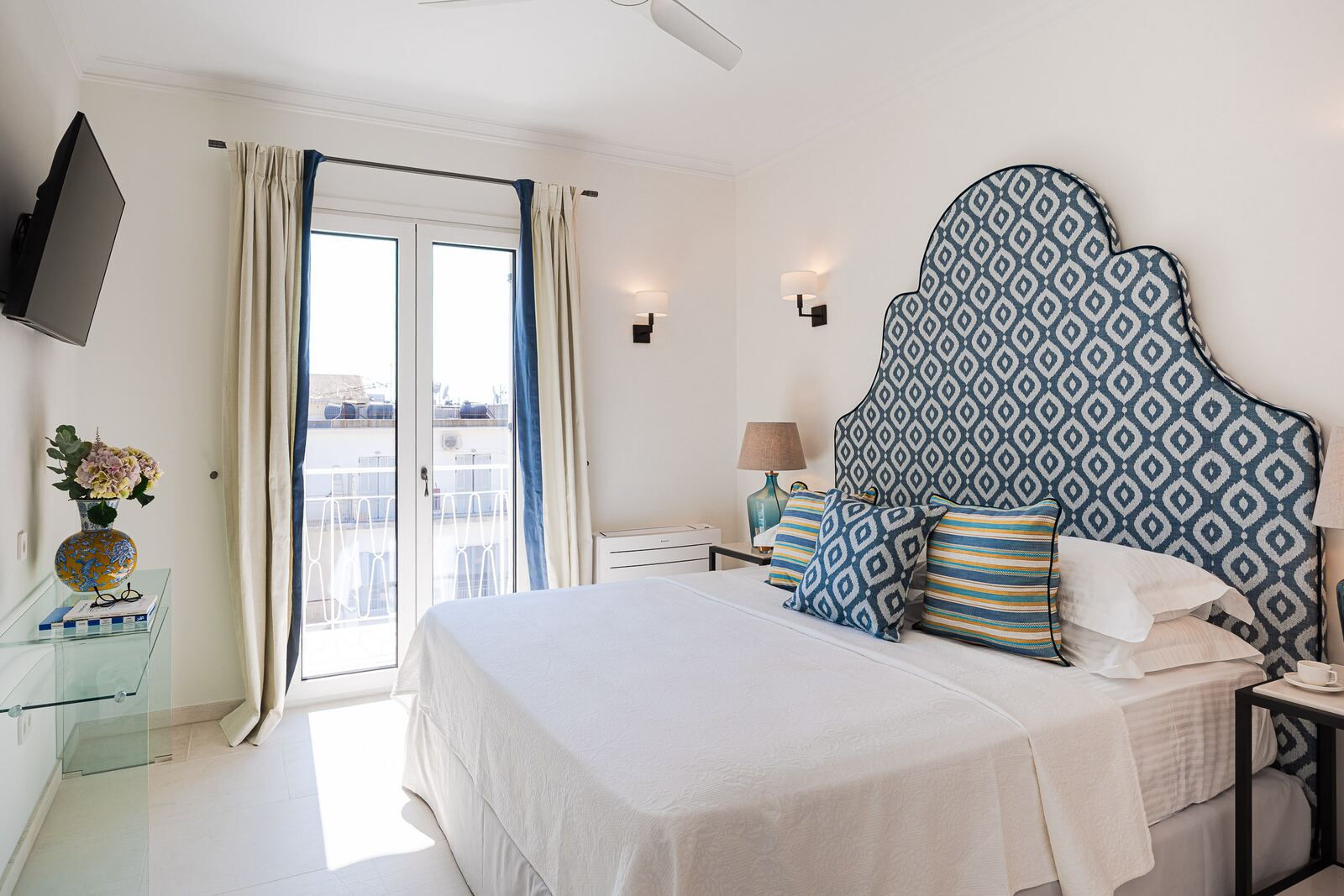Bedroom two with its own balcony door and smart television