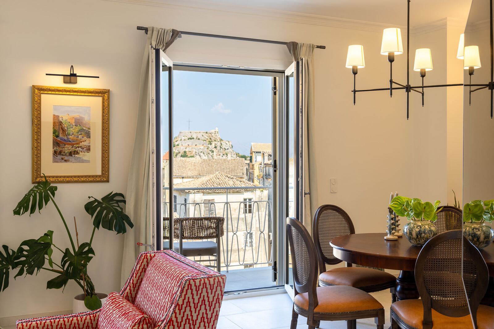 Dining area with the balcony doors open onto the town