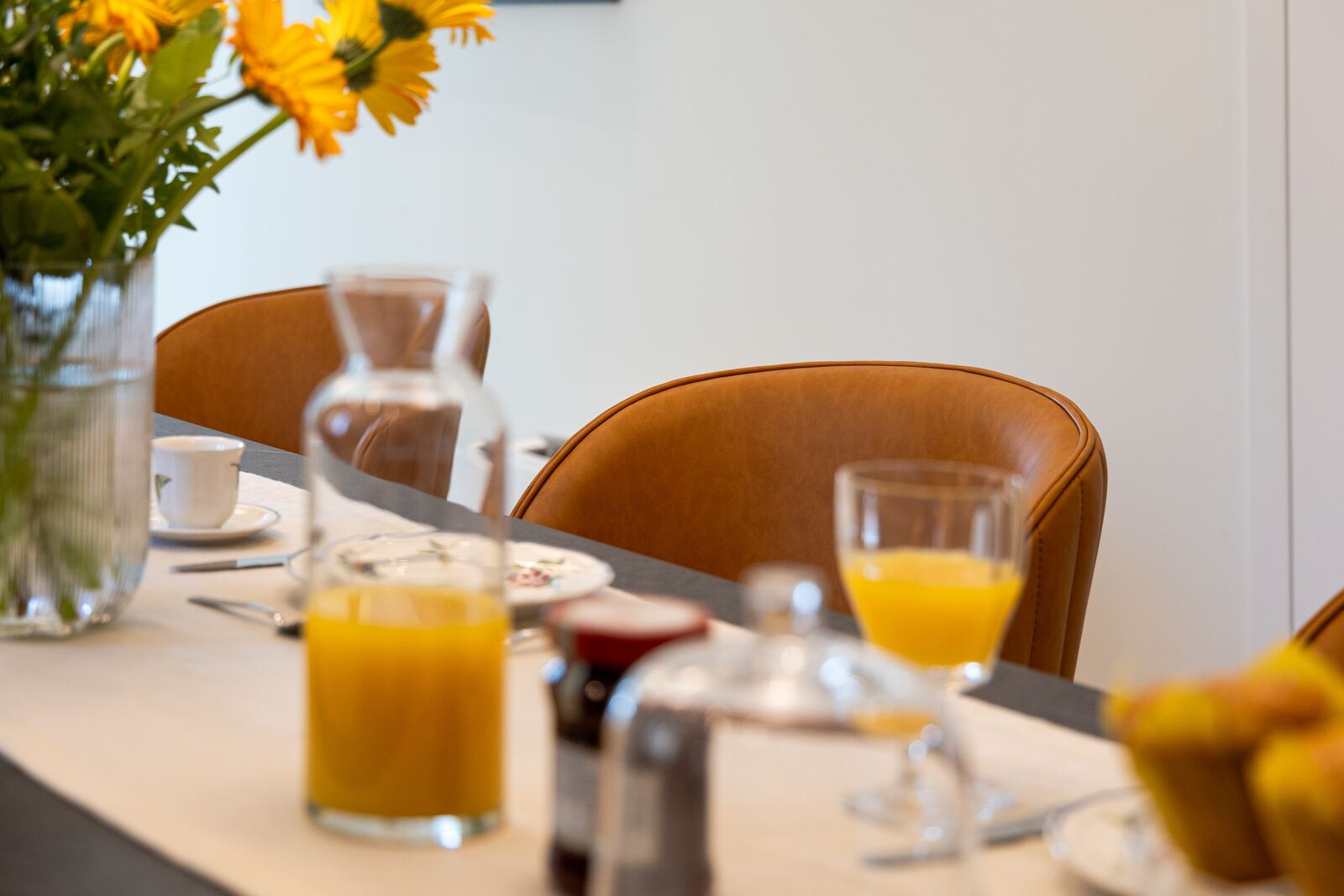 Breakfast detail: fresh juice, coffee and sunflowers on the island