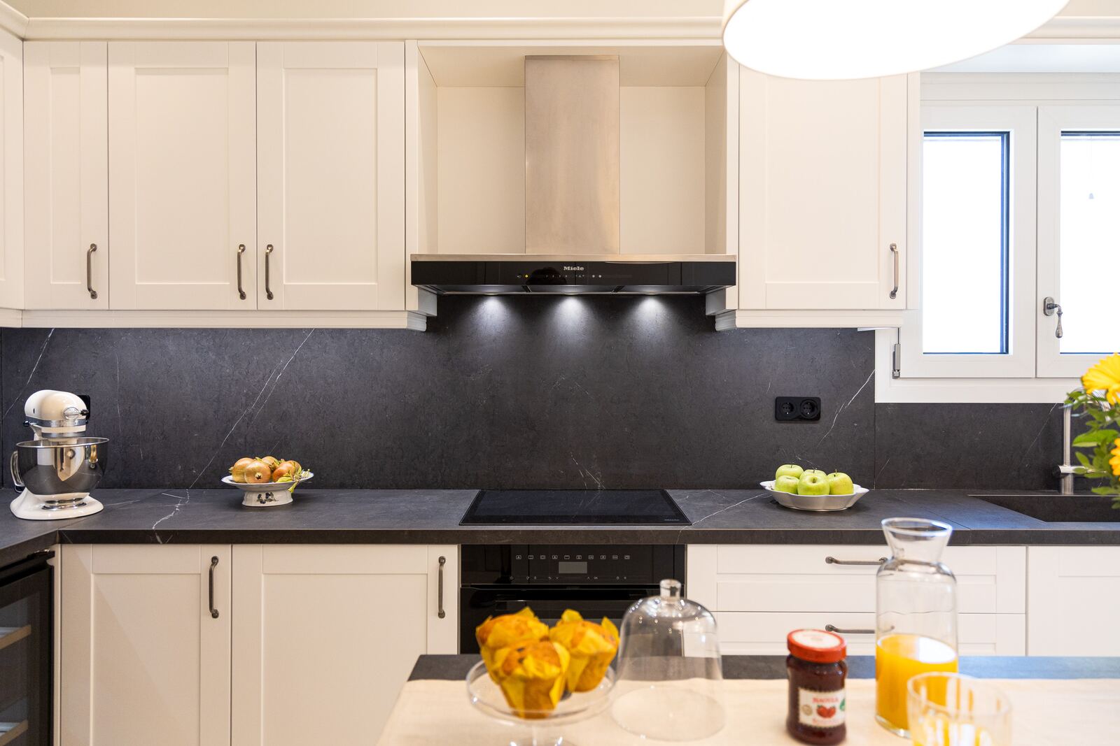 Kitchen run with stone worktop, oven and stand mixer