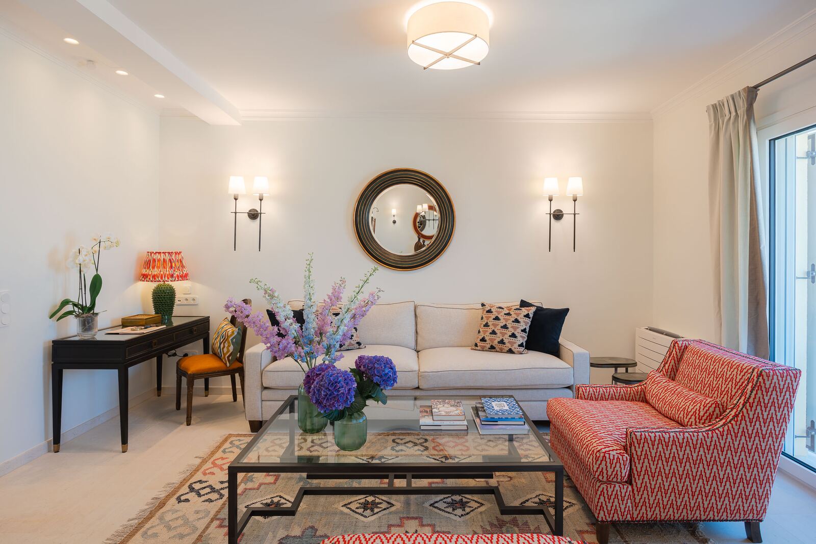 Linen sofa, gilt mirror and printed armchairs in the living room